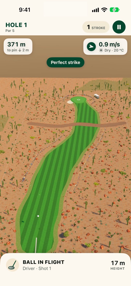 A perfect drive in flight over the desert course, the fairway winding toward the green.